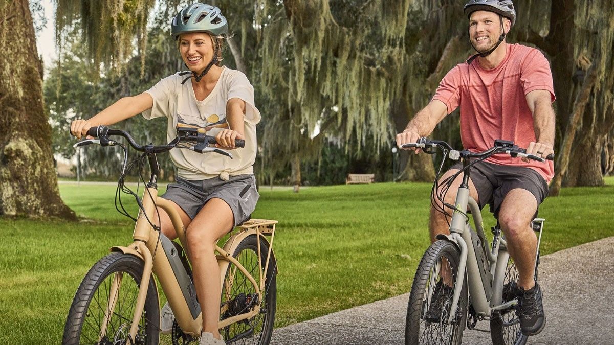 Man and woman riding Pacific Cycle Ascend Cabrillo e-bikes