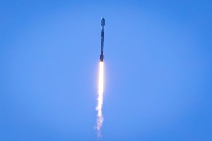 Falcon rocket launching into the sky from SpaceX facility
