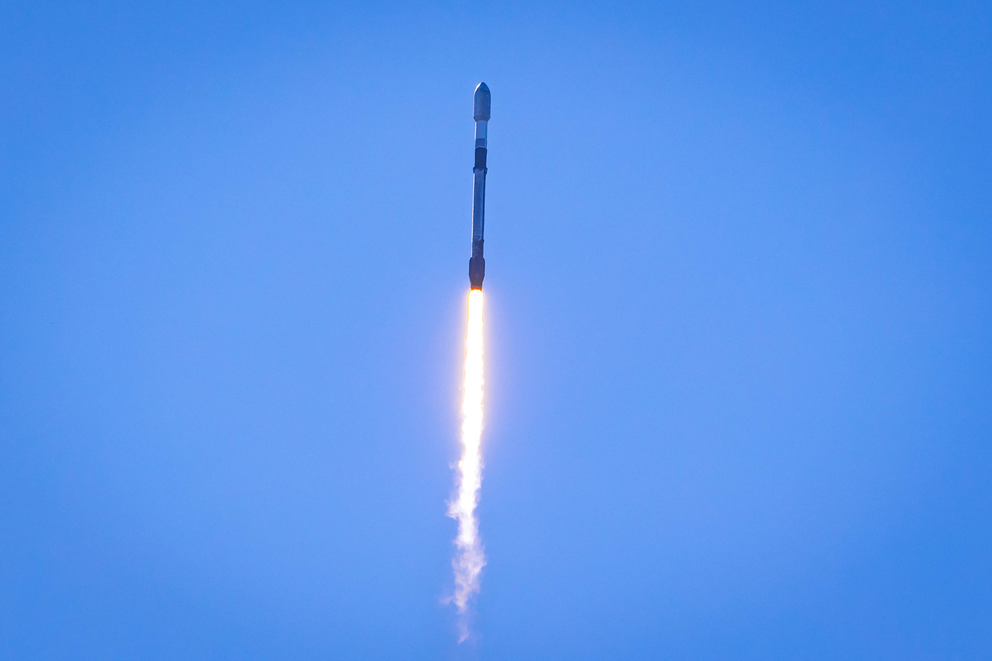 Falcon rocket launching into the sky from SpaceX facility