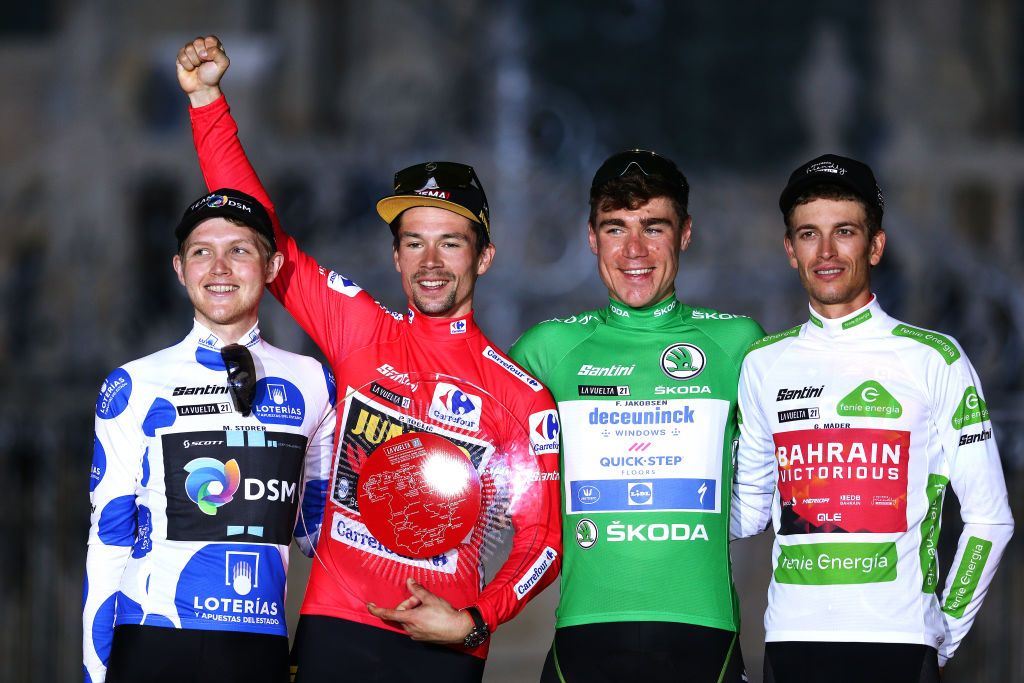 SANTIAGO DE COMPOSTELA SPAIN SEPTEMBER 05 LR Michael Storer of Australia and Team DSM polka dot mountain jersey Primoz Roglic of Slovenia and Team Jumbo Visma red leader jersey Fabio Jakobsen of Netherlands and Team Deceuninck QuickStep green points jersey and Gino Mder of Switzerland and Team Bahrain Victorious white best young jersey celebrate on the podium ceremony in the Plaza del Obradoiro after during the 76th Tour of Spain 2021 Stage 21 a 338 km Individual Time Trial stage from Padrn to Santiago de Compostela lavuelta LaVuelta21 ITT on September 05 2021 in Santiago de Compostela Spain Photo by Gonzalo Arroyo MorenoGetty Images