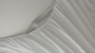 Close up of elasticated skirt on Puffy Deluxe Mattress Topper