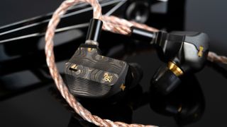 Campfire Audio Chimera wired in-ear headphones on a black surface 