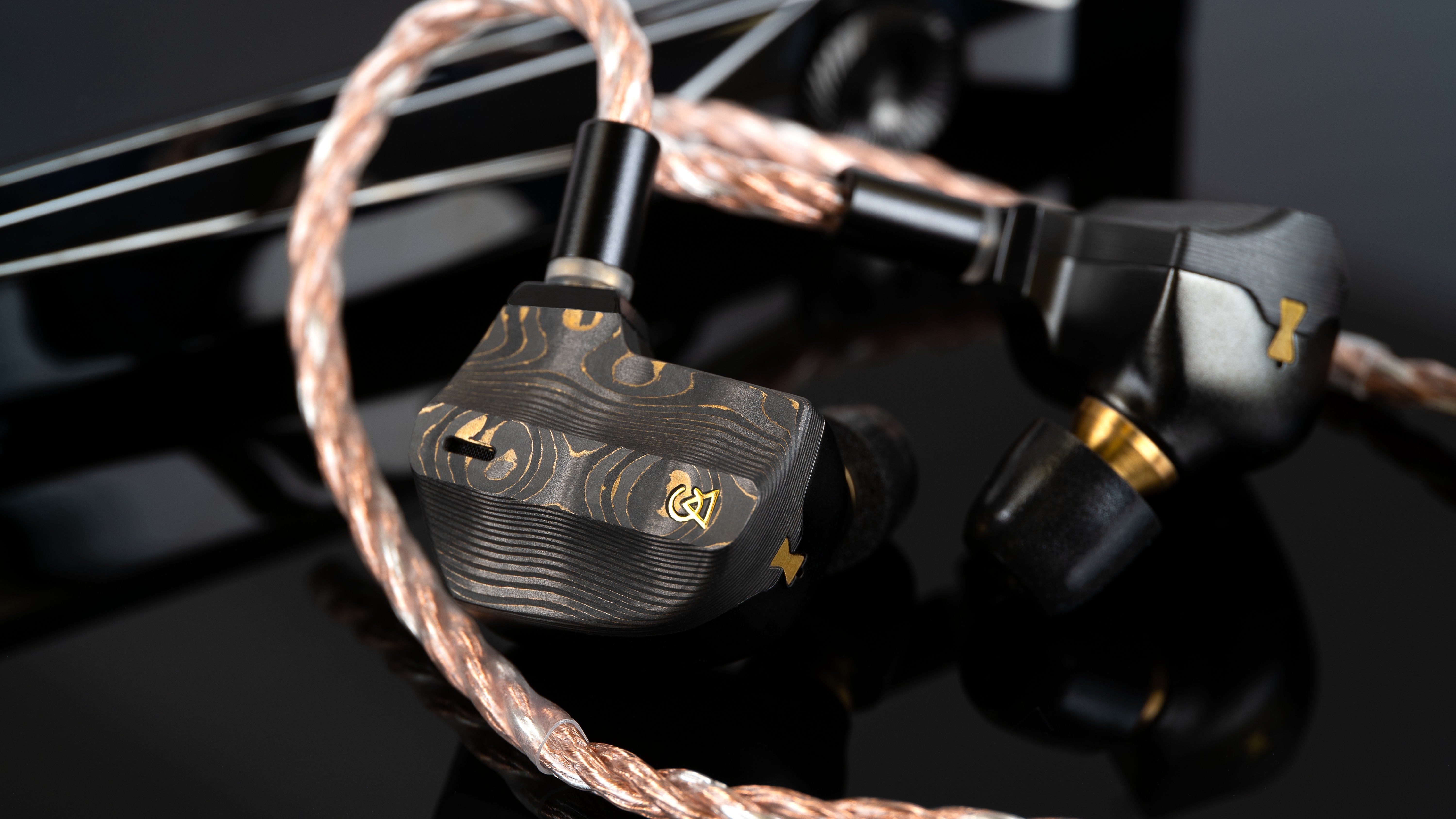 Campfire Audio Chimera wired in-ear headphones on a black surface 