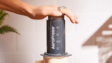 AeroPress Original being pressed in front of a wall