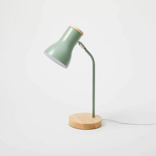 A green lamp with wooden base