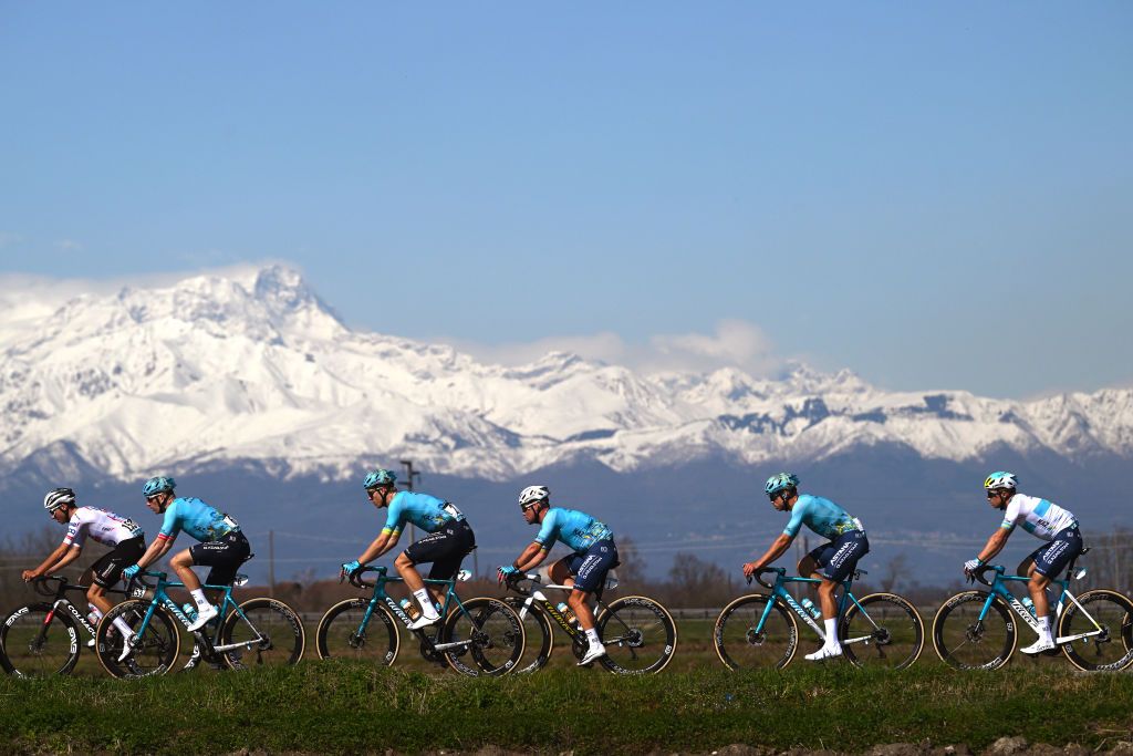 SALASSA ITALY MARCH 13 LR Cees Bol of The Netherlands Mark Cavendish of Great Britain and Astana Qazaqstan Team a general view of the peloton competing with the Alps in the background during the 105th MilanoTorino 2024 a 177km one day race from Rho to Salassa 346m on March 13 2024 in Salassa Italy Photo by Dario BelingheriGetty Images