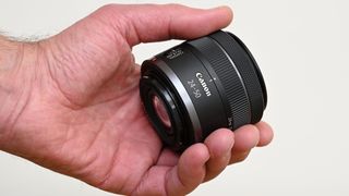 Canon RF 24-50mm F4.5-6.3 IS STM being held in reviewer's hand