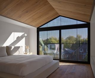 bedroom and large window at Everden house by archollab