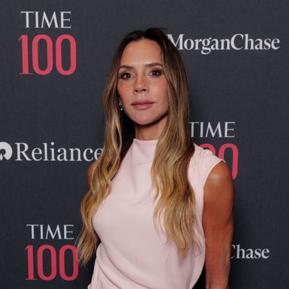 Victoria Beckham on the red carpet wearing a light pink dress