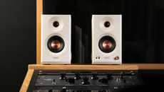 Edifier MR5 studio speakers photographed in a recording studio where they're sitting above the mixing desk
