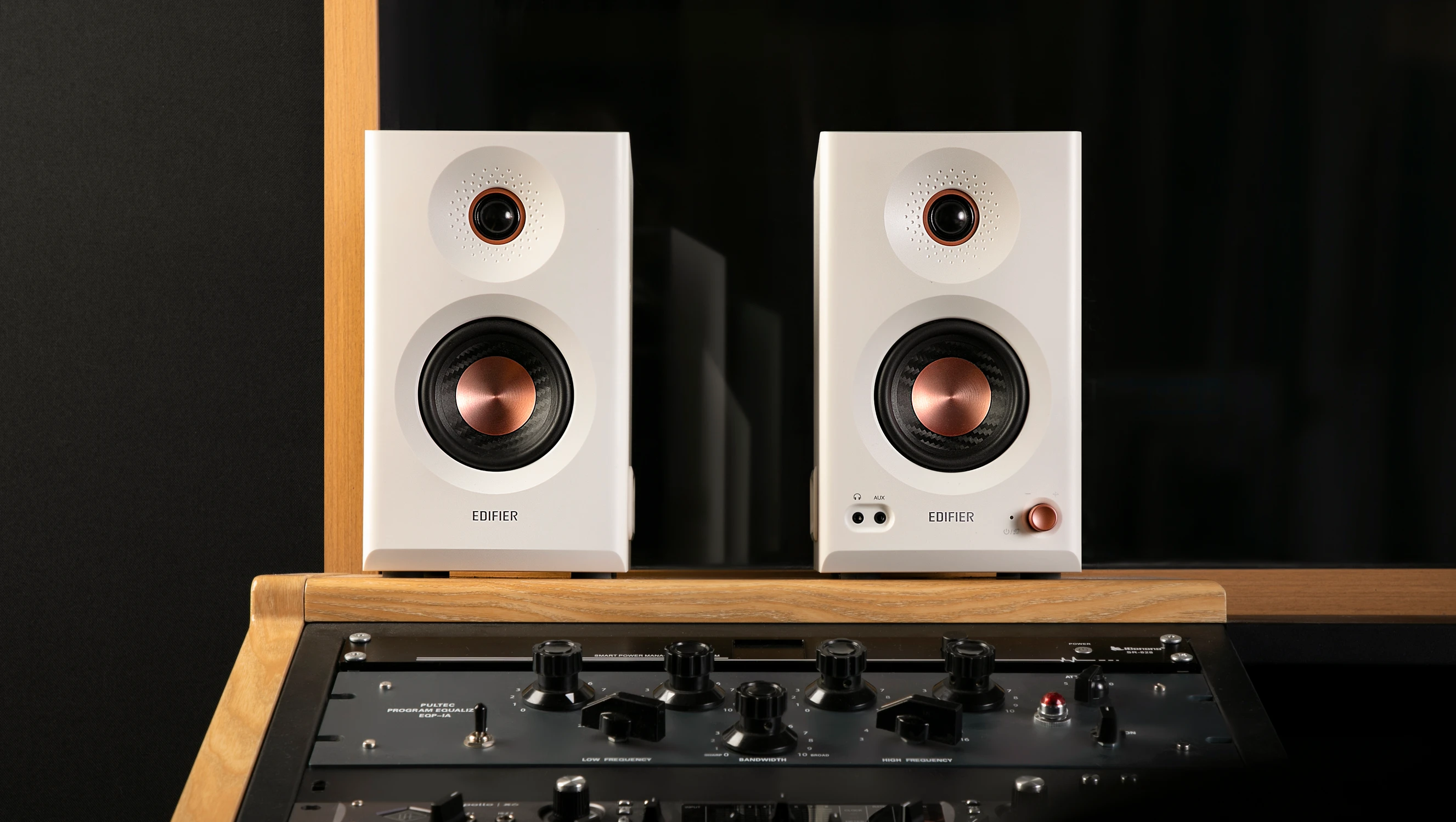 Edifier MR5 studio speakers photographed in a recording studio where they&#039;re sitting above the mixing desk