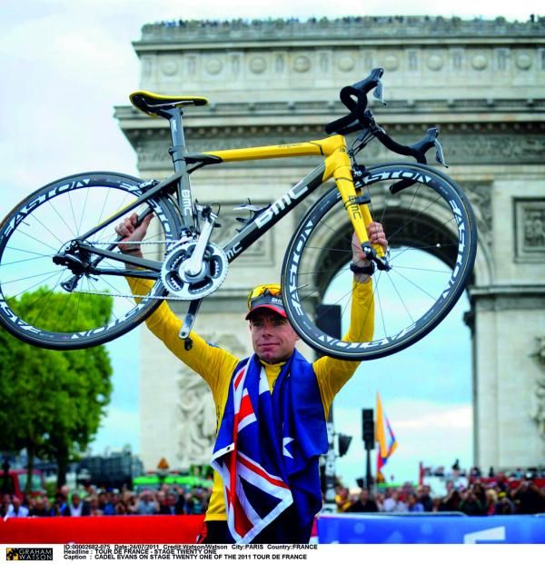 20 years in the making. A happy Evans raises his bike, draped in an Australian flag.