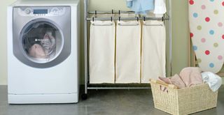 laundry room with laundry baskets for separates to show how to soften towels when washing