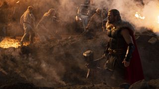 Thor walks onto the battlefield with Stormbreaker in hand in Thor: Love and Thunder