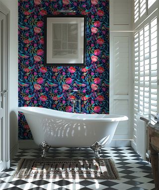 pink and blue floral wallpaper behind white slipper bath