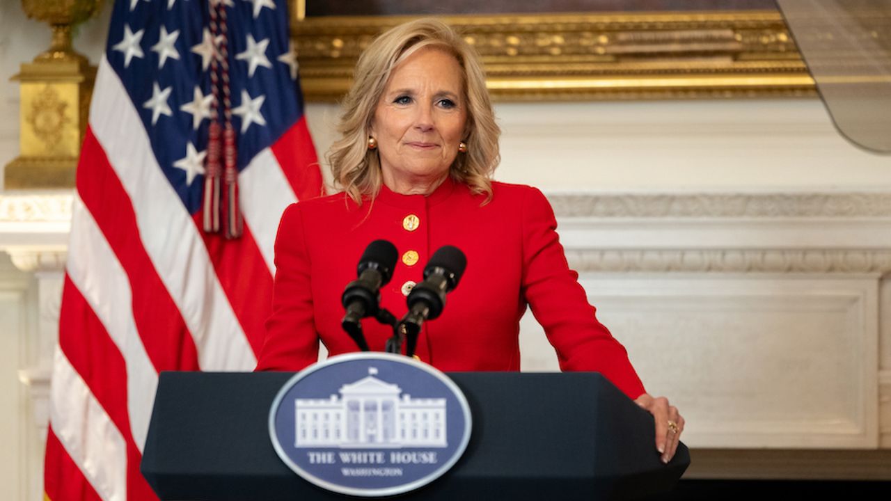 Jill Biden at the White House podium wearing a custom red schiaparelli suit