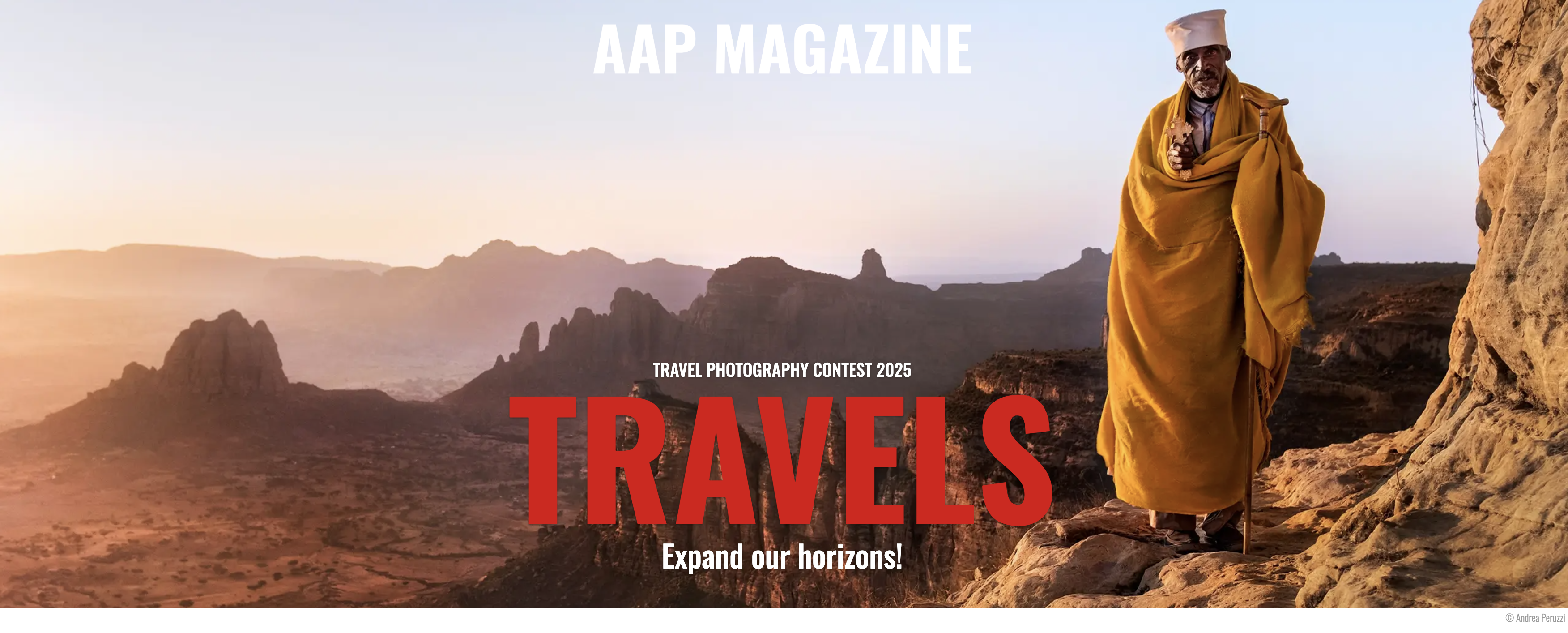 A man draped in a yellow cloth stands on a rocky ledge at sunrise, overlooking rugged mountains. Text reads &quot;AAP Magazine Travels: Expand our horizons!&quot;