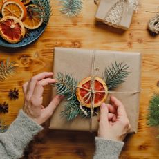 Wrapping festive gifts with sustainable paper and natural foliage