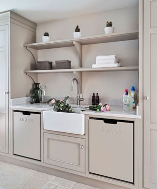 Laundry room with dedicated pull out bins for light and dark washing colors