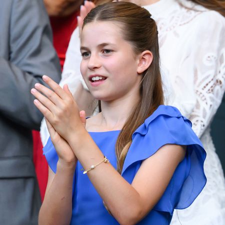 Princess Charlotte clapping in a blue dress