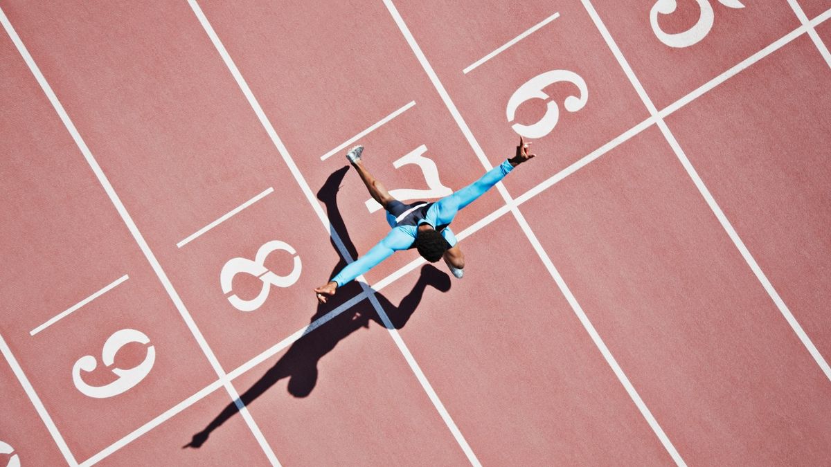 runner crossing line on a track