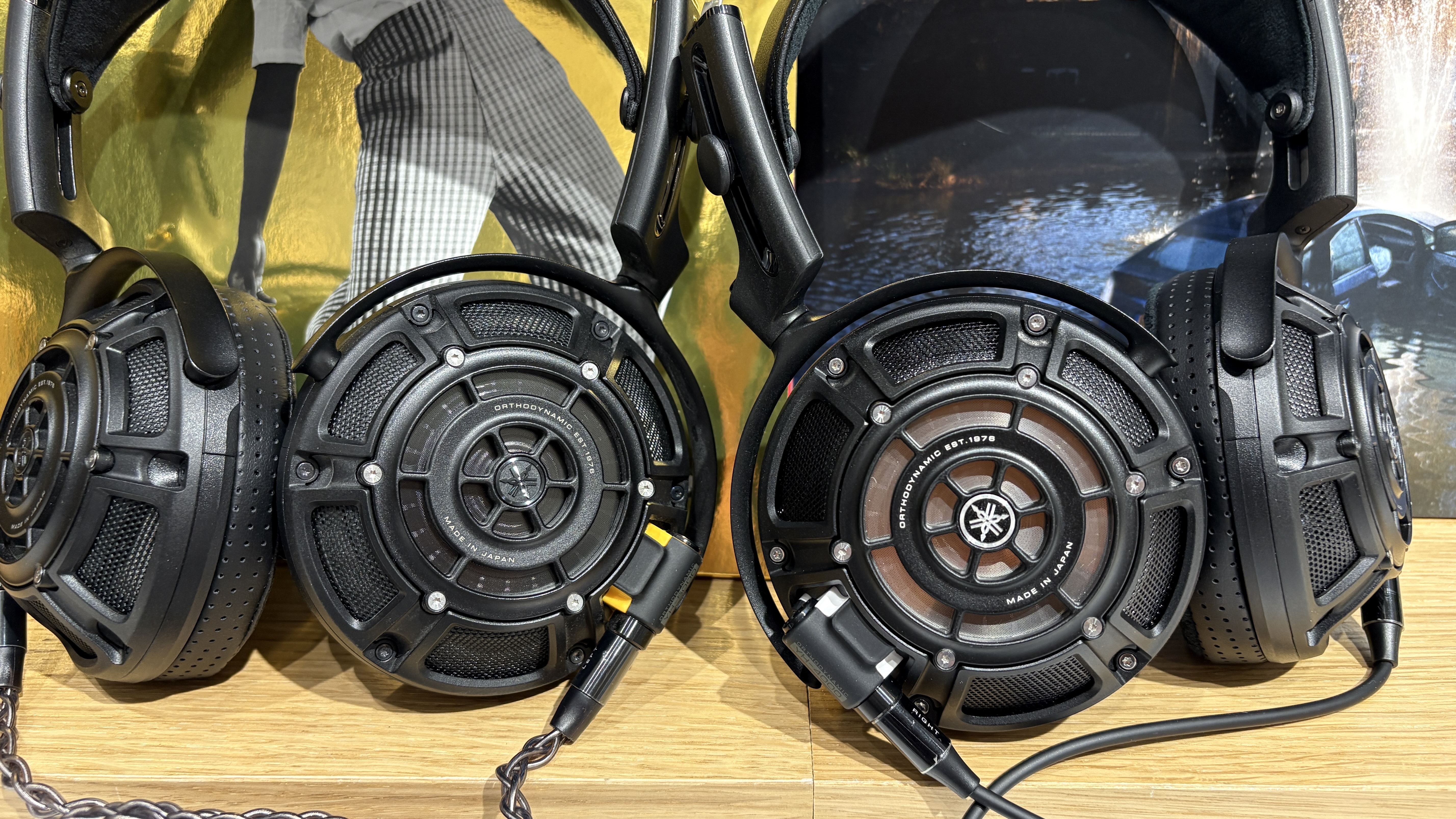 Yamaha YH-5000SE and YH-4000 headphones side-by-side on a desk with vinyl records in background