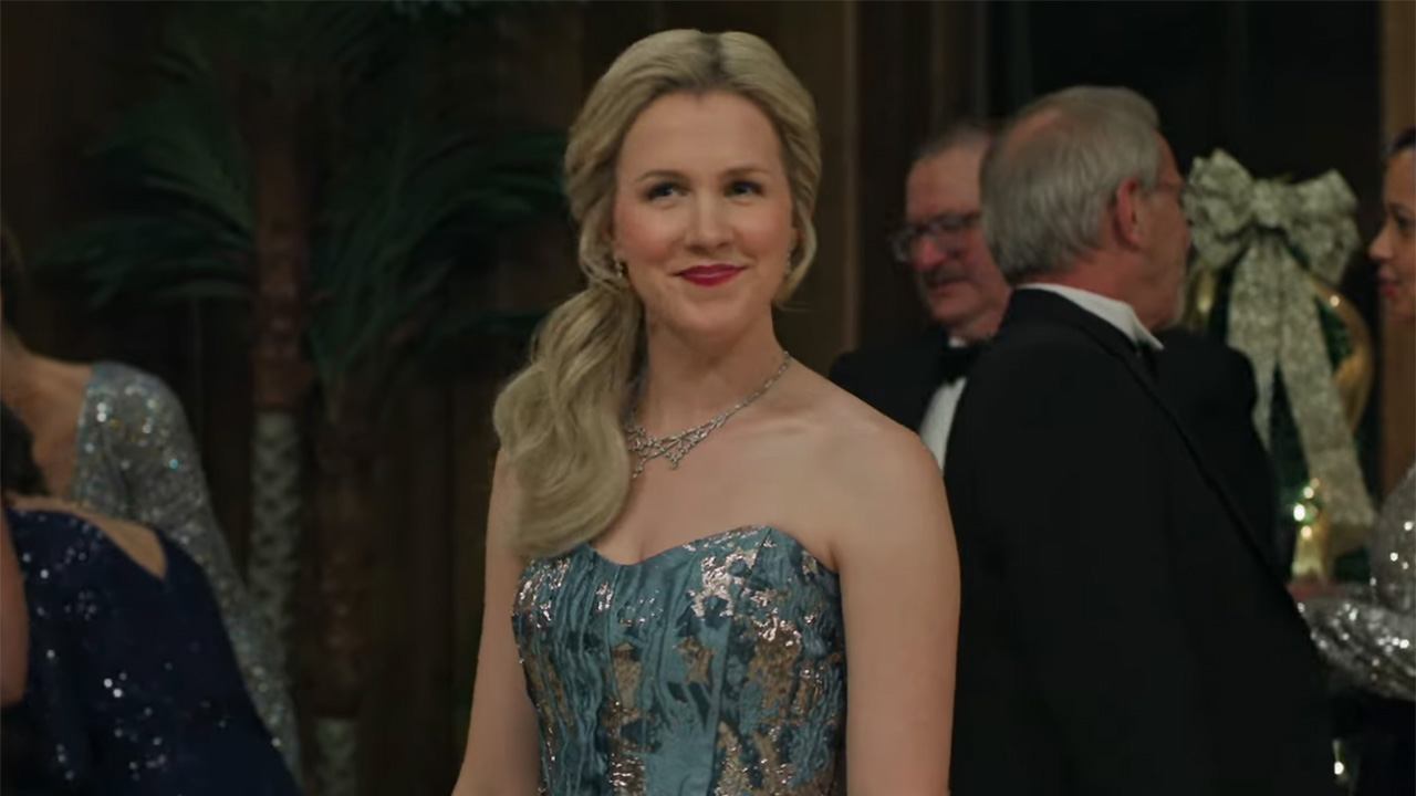 Ginna Claire Mason in her strapless Nordstrom Rack shiny dress with her hair in a low ponytail and red lipstick in A Newport Christmas.