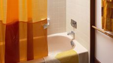 Orange shower curtain in a bathroom