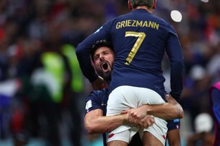Olivier Giroud hugs Antoine Griezmann after the two combined for France's winner against England at the 2022 World Cup.