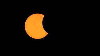 Partial solar eclipse Indonesia, April 20, 2023. The partial solar eclipse looks like the moon has taken a bite out of the sun.