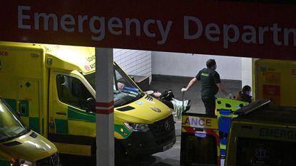 A paramedic wheels a patient into Guy's and St Thomas' Hospital, London.
