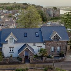 sloping roof house in blue and brown colour
