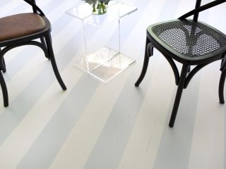Painted wide stripes on wood flooring in soft gray and white