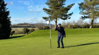 Female golfer celebrating a putt