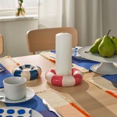 A set dining table with two IKEA TR&Auml;DSTAM candle holders in the middle