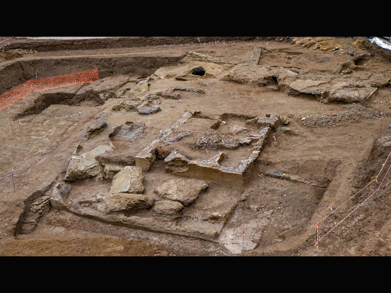 A view of the excavation site. We see dirt and stones.