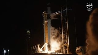 a black-and-white spacex falcon 9 rocket launches into a night sky.