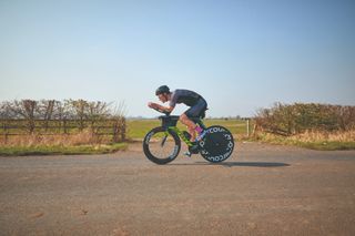 Male cyclist riding a time trial bike