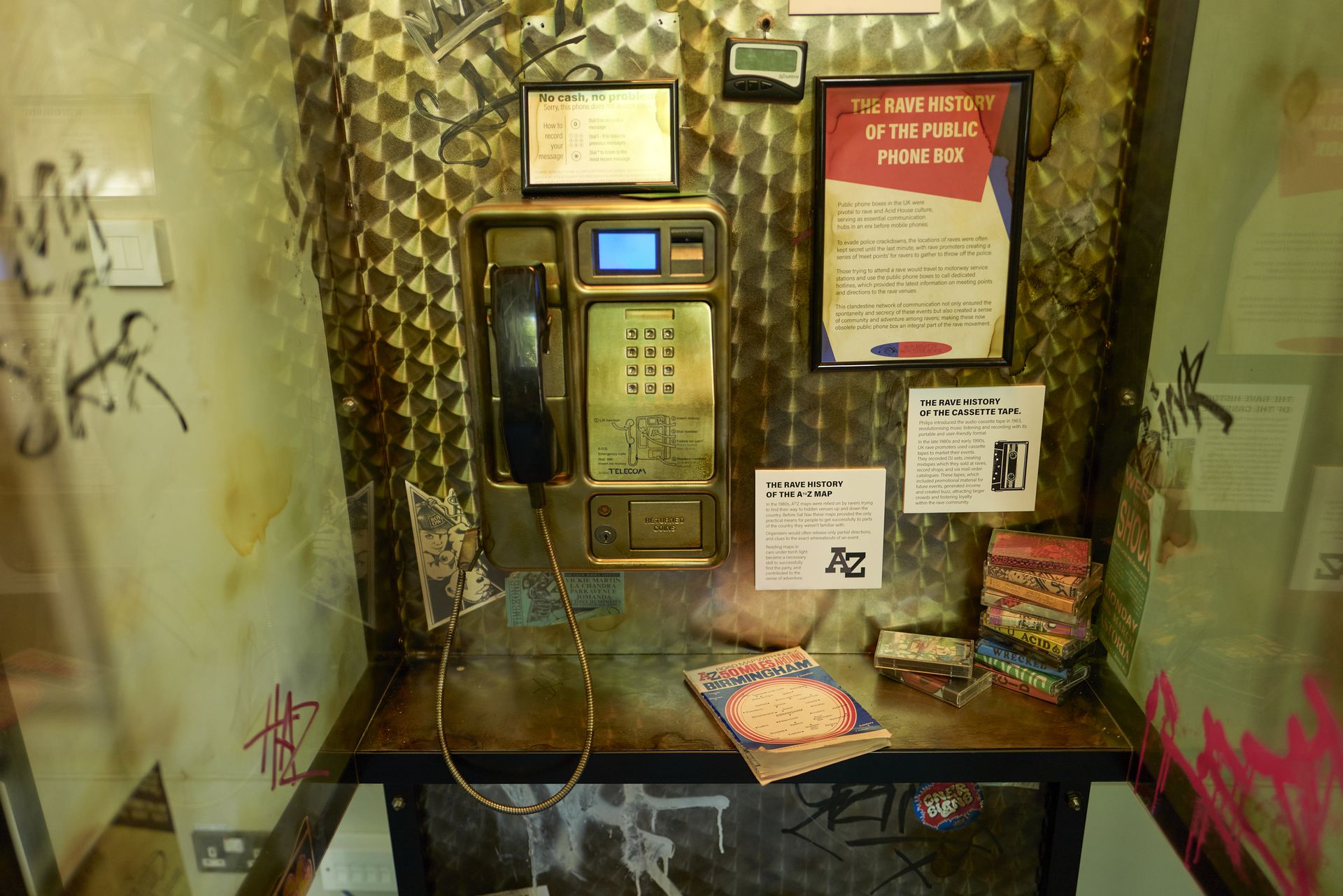 interior of an old UK payphone box with graffiti