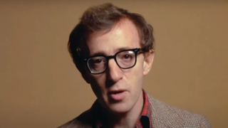Woody Allen telling a joke in front of a colored background in Annie Hall.