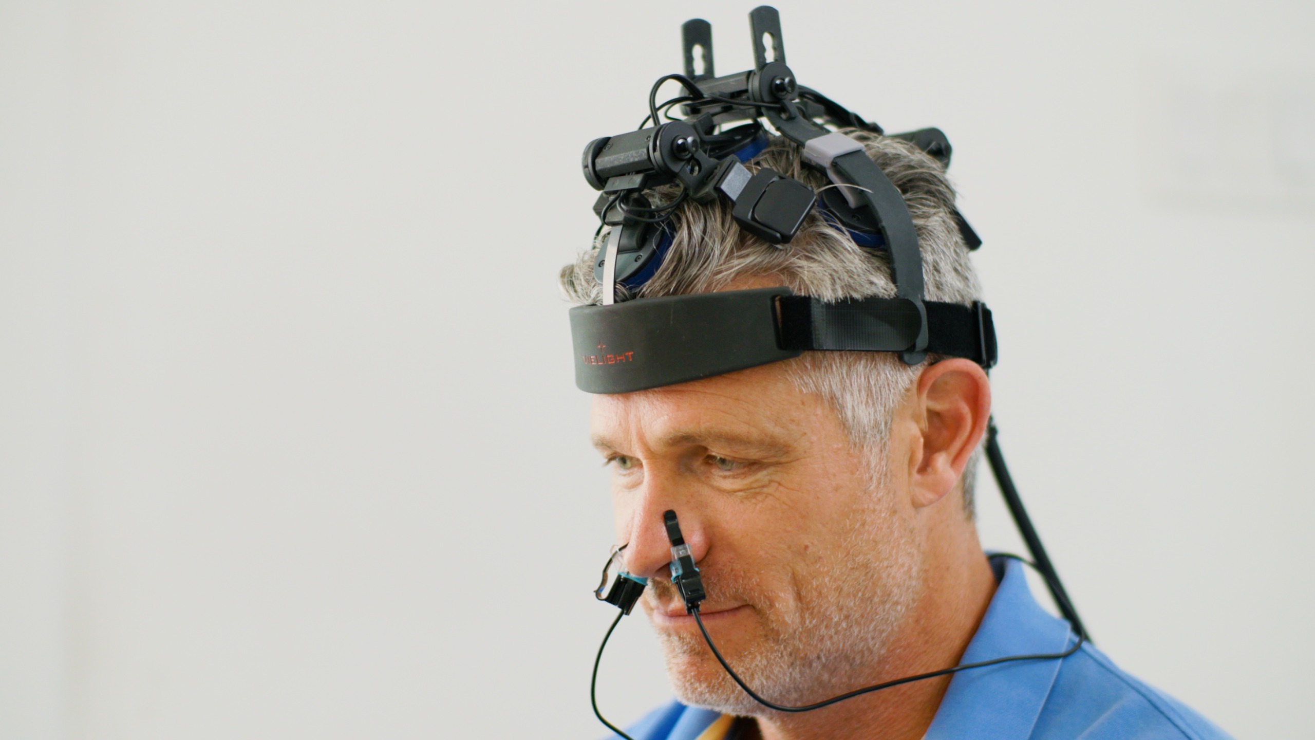 A man wearing a headset that plugs into his nose