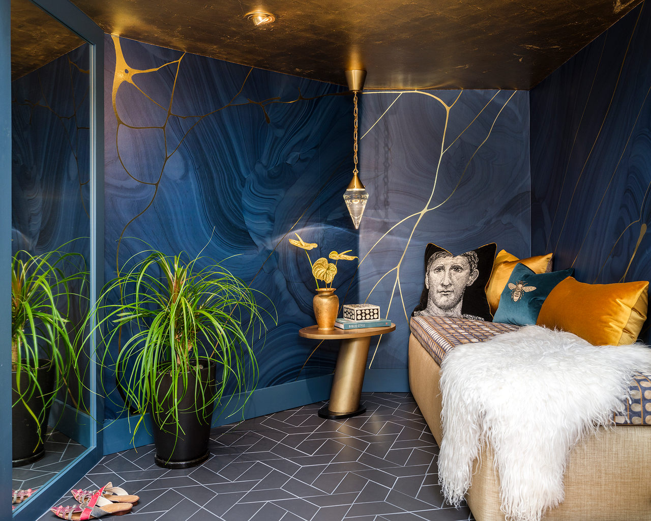 A small lounge area with gold leafing on the ceiling