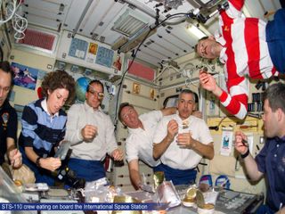 STS-110 Crew Eating on Board ISS