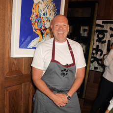 Tom Kerridge smiling in a grey apron.