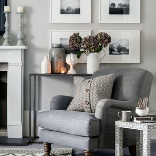 Grey armchair with knitted cushion