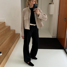 Anouk wearing a suede jacket and black loafers