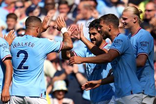 Ilkay Gundogan of Manchester City celebrates with team mate Kyle Walker after scoring their sides first goal during the Premier League match between Manchester City and AFC Bournemouth at Etihad Stadium on August 13, 2022 in Manchester, England.