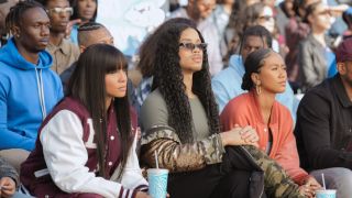 Simone, Nathaniel and Keisha sitting in the bleachers at a football game in All-American: Homecoming Season 3 premiere