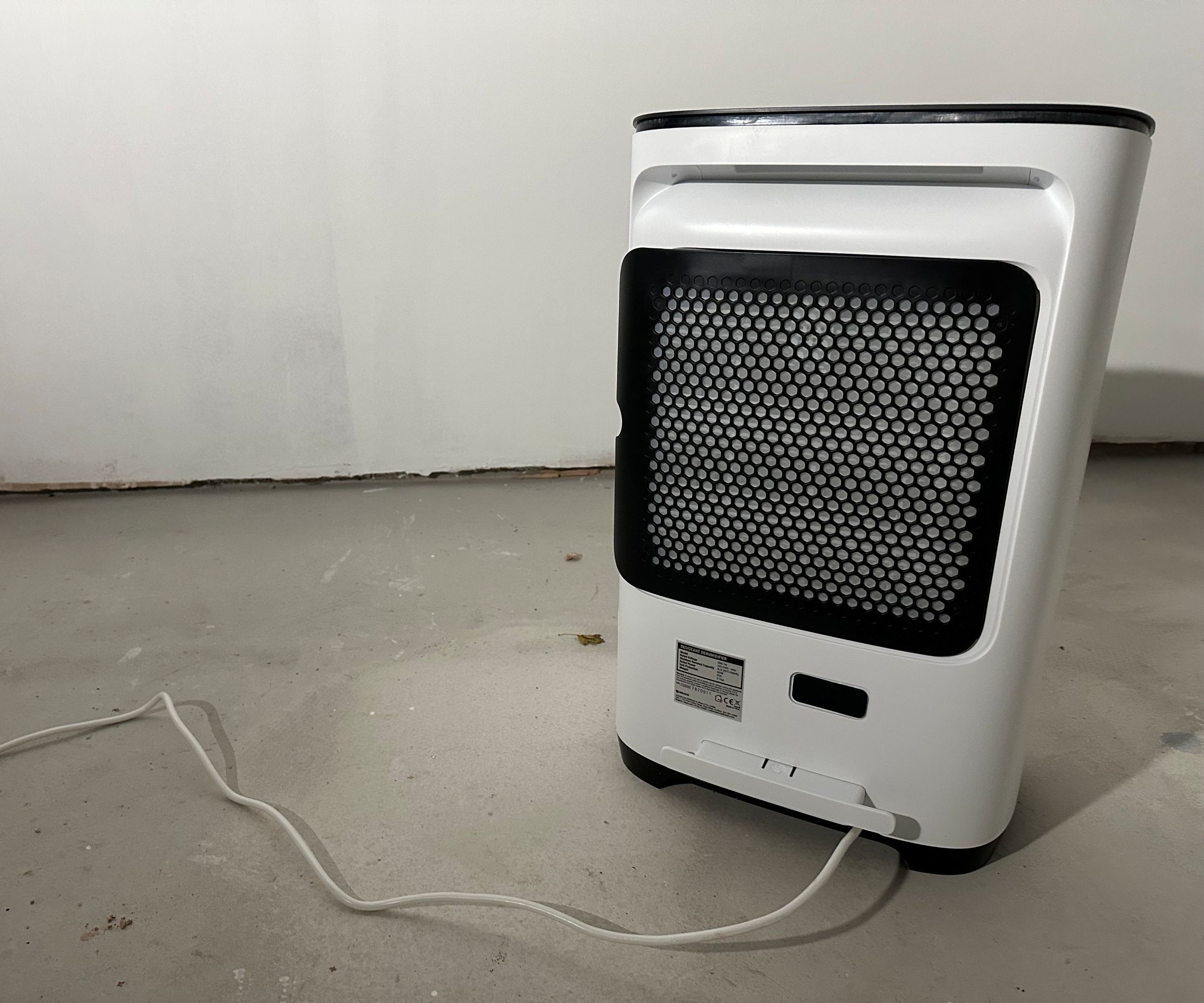 A dehumidifier seen from behind with a black grate