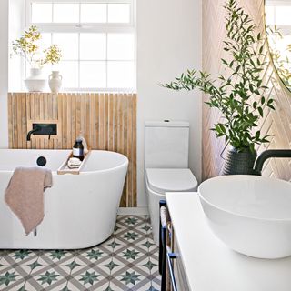 Bathroom with tiles floors and wall and wood panelling on wall behind bath